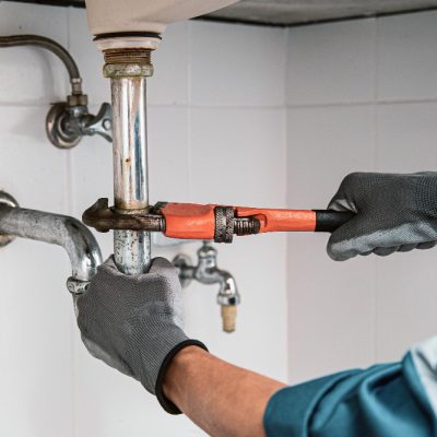 plumber-using-wrench-repair-water-pipe-sink plumber-using-wrench-repair-water-pipe-sink