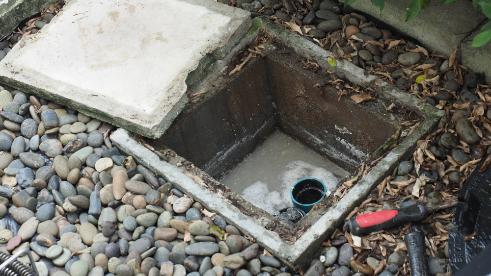 drain-cleaning-plumber-repairing-clogged-grease-trap-with-auger-machine-maintenance-sewage-system-grease-trap-by-professional-plumber-using-auger-snake-fix-unclog-drain drain-cleaning-plumber-repairing-clogged-grease-trap-with-auger-machine-maintenance-sewage-system-grease-trap-by-professional-plumber-using-auger-snake-fix-unclog-drain